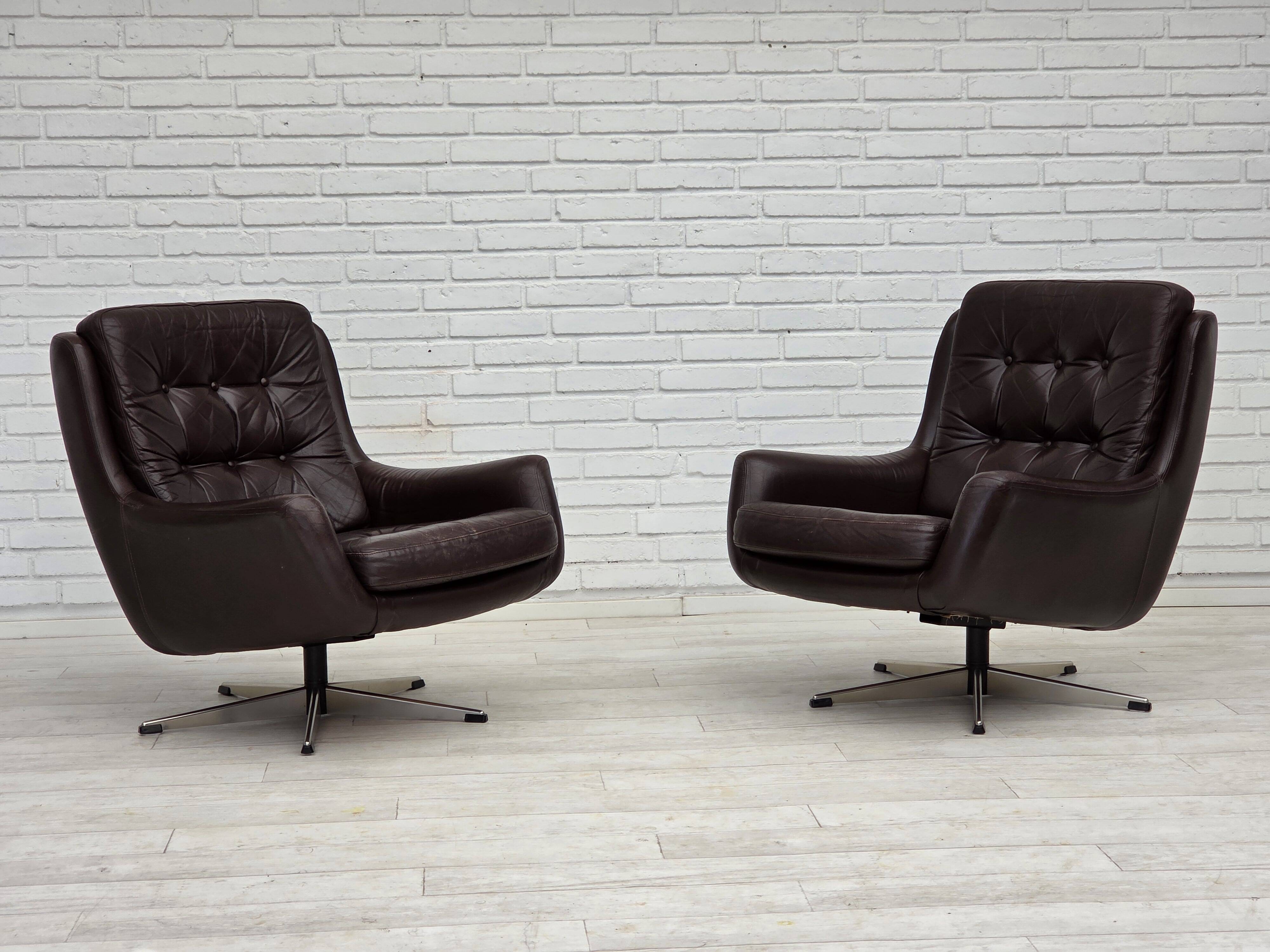1970s, set of two swivel lounge chairs with footstool, leather.