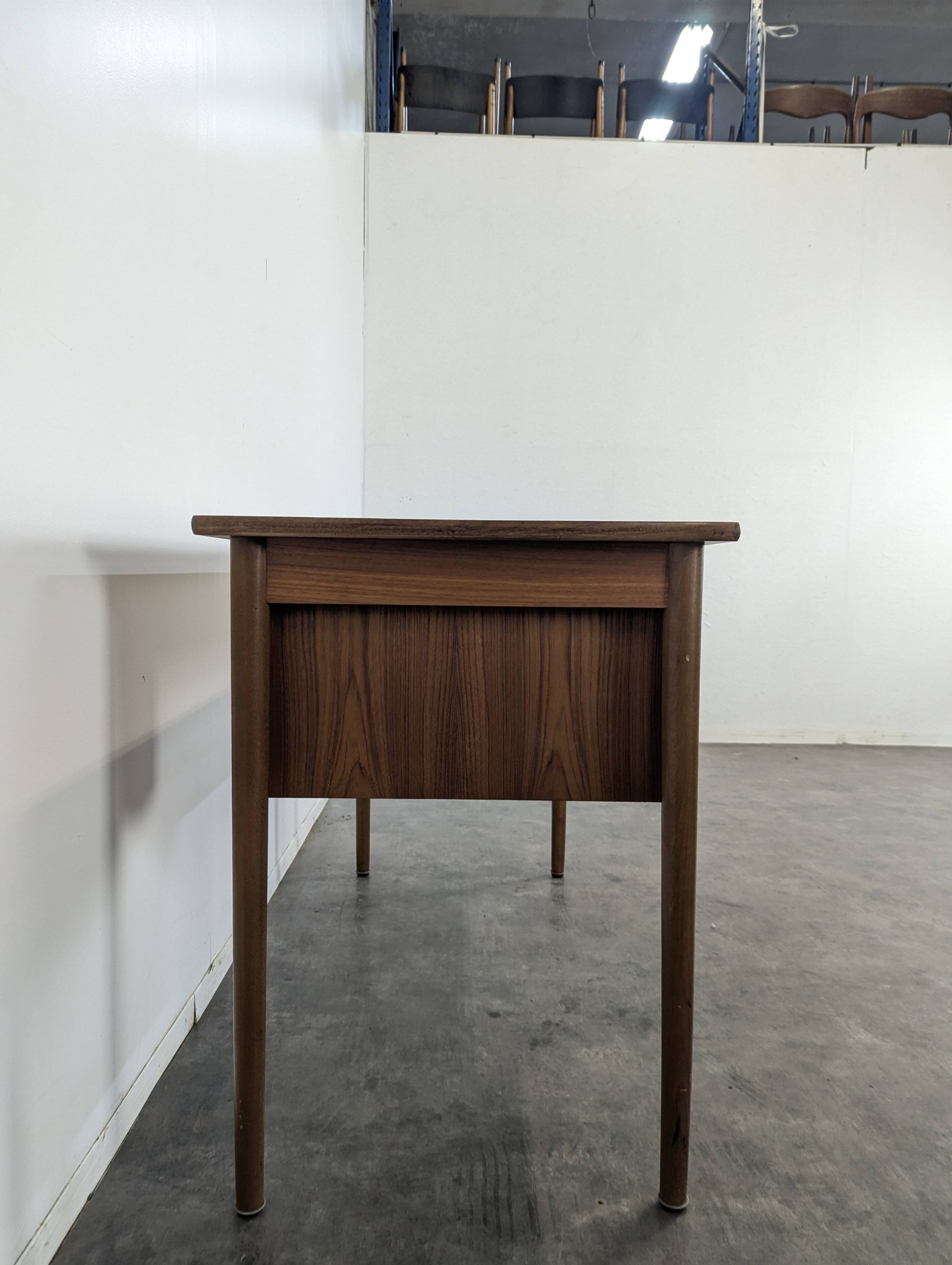 Scandinavian teak desk with a suspended drawer unit.