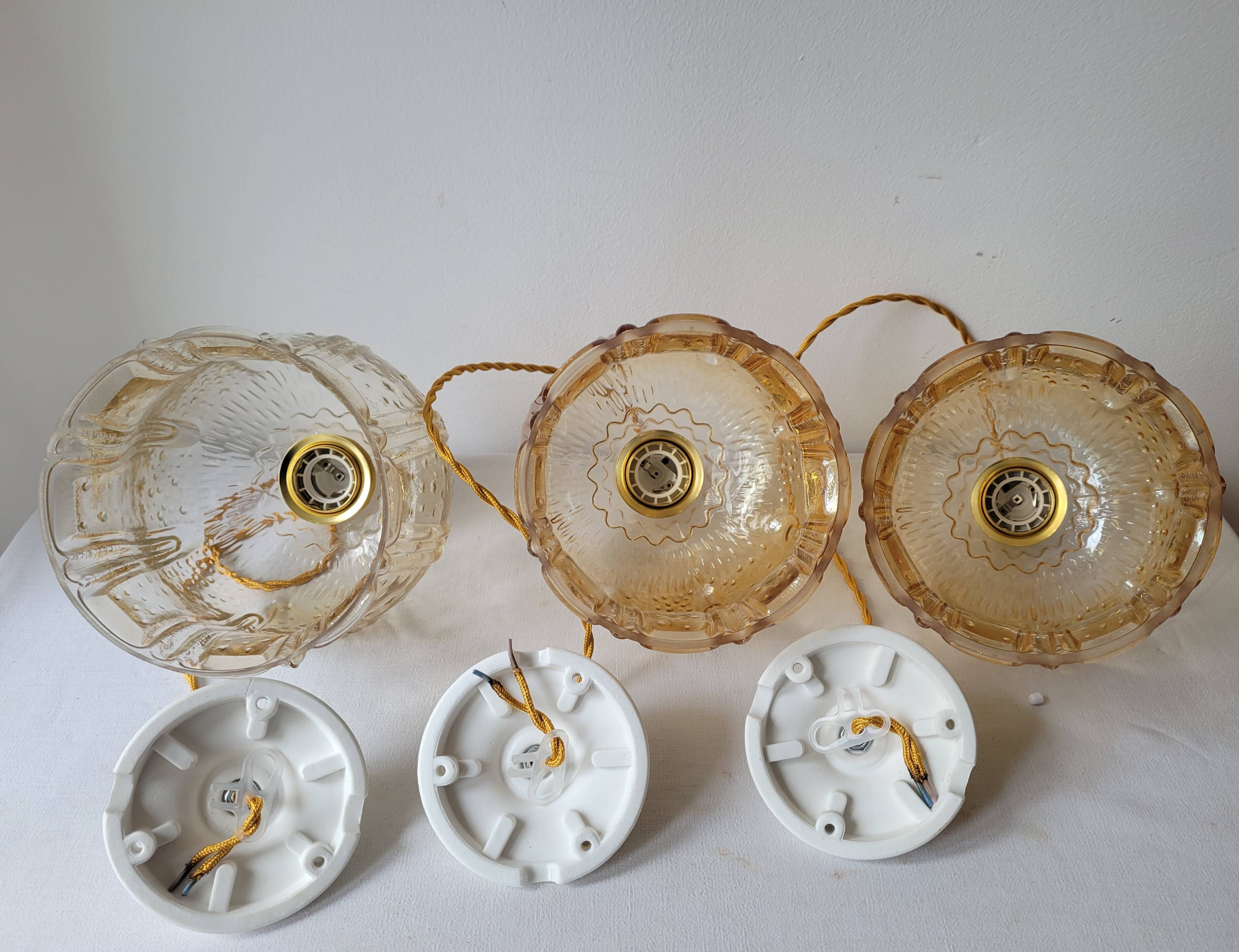 Trio of amber glass pendant lights