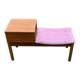 Mid-Century telephone bench in teak with bright pink fabric seat and wooden top.