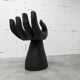 Black armchair chair in carved wood in the shape of a hand