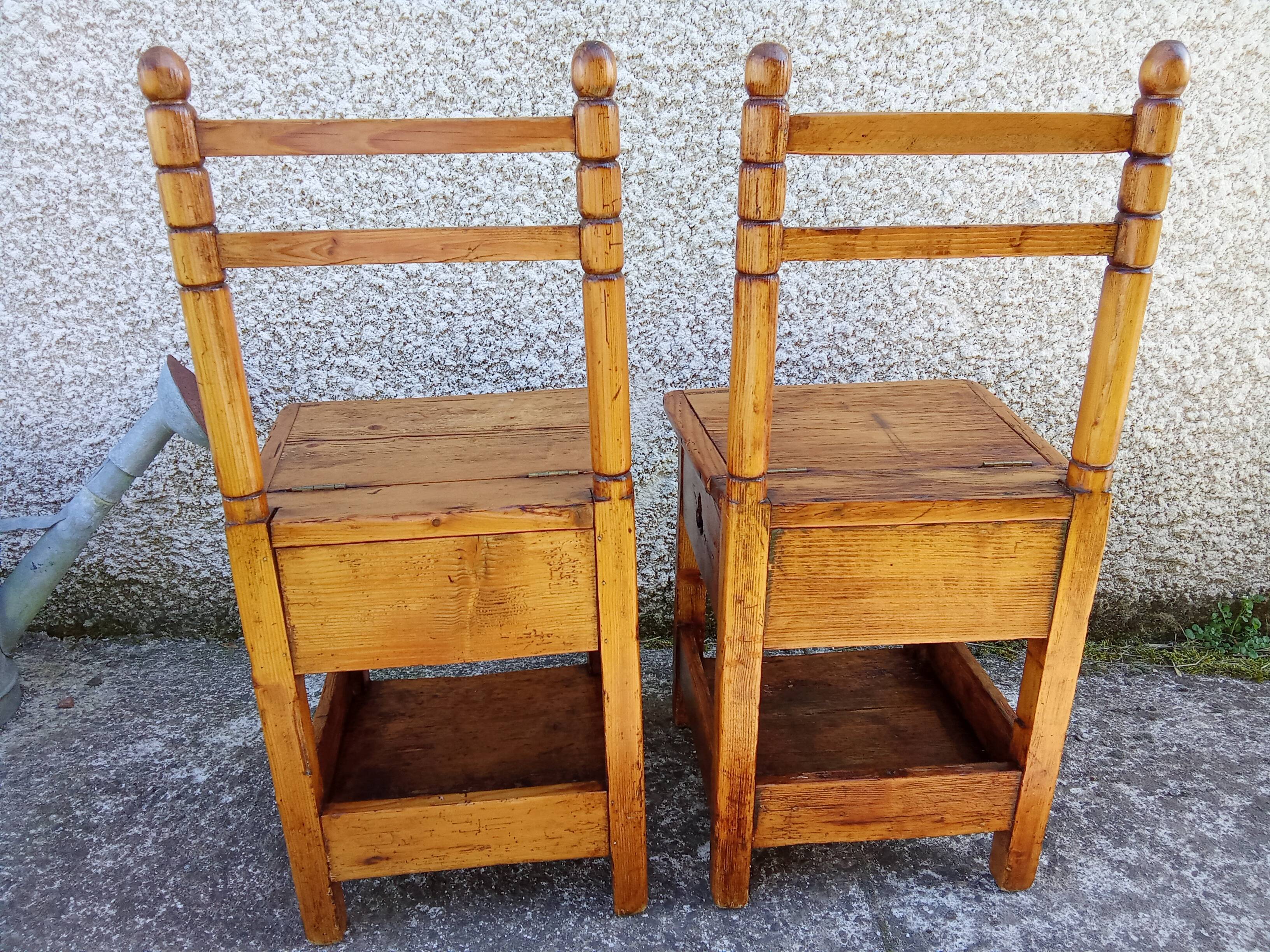 2 old wooden children's chairs with a small chest.
