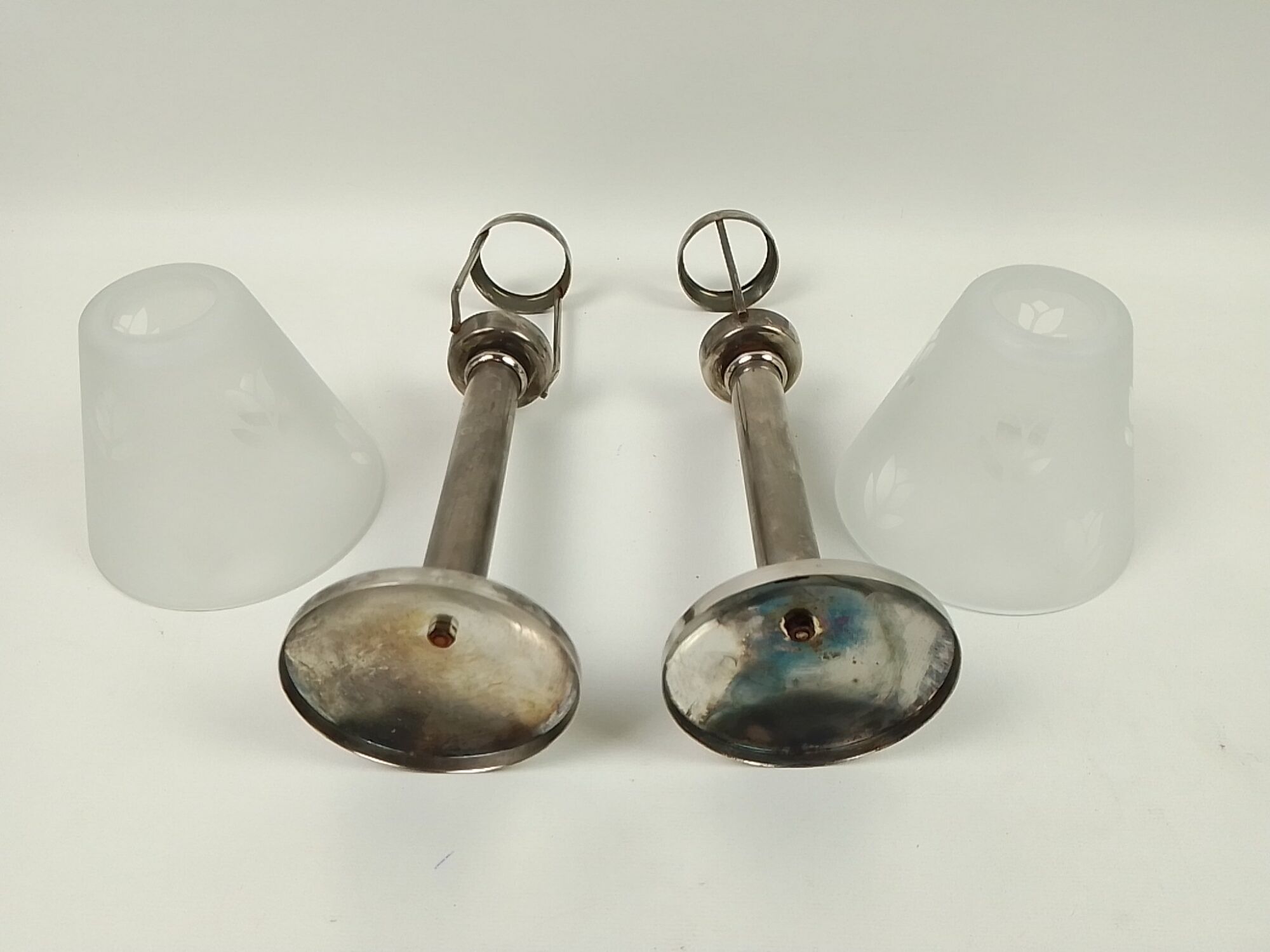 Pair of metal candlesticks with glass lampshade