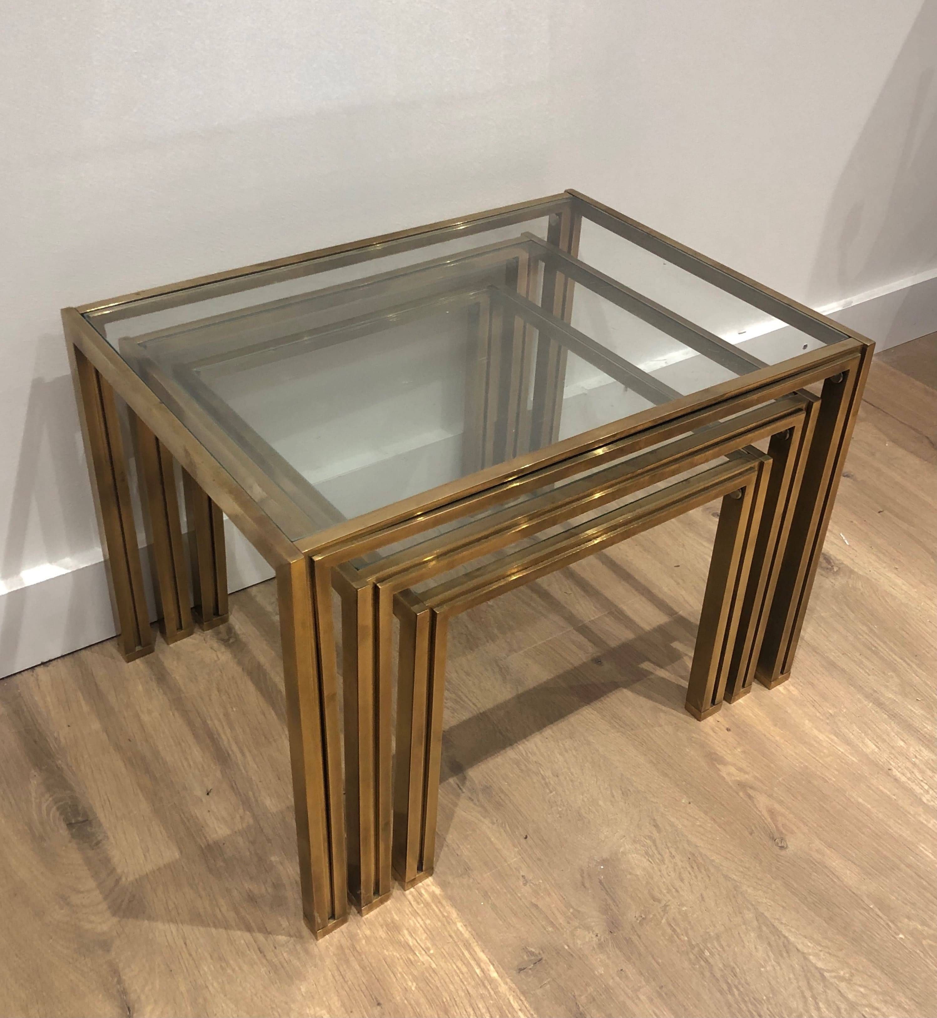 Set of 3 nesting tables in brass and glass. French work by Guy Lef.