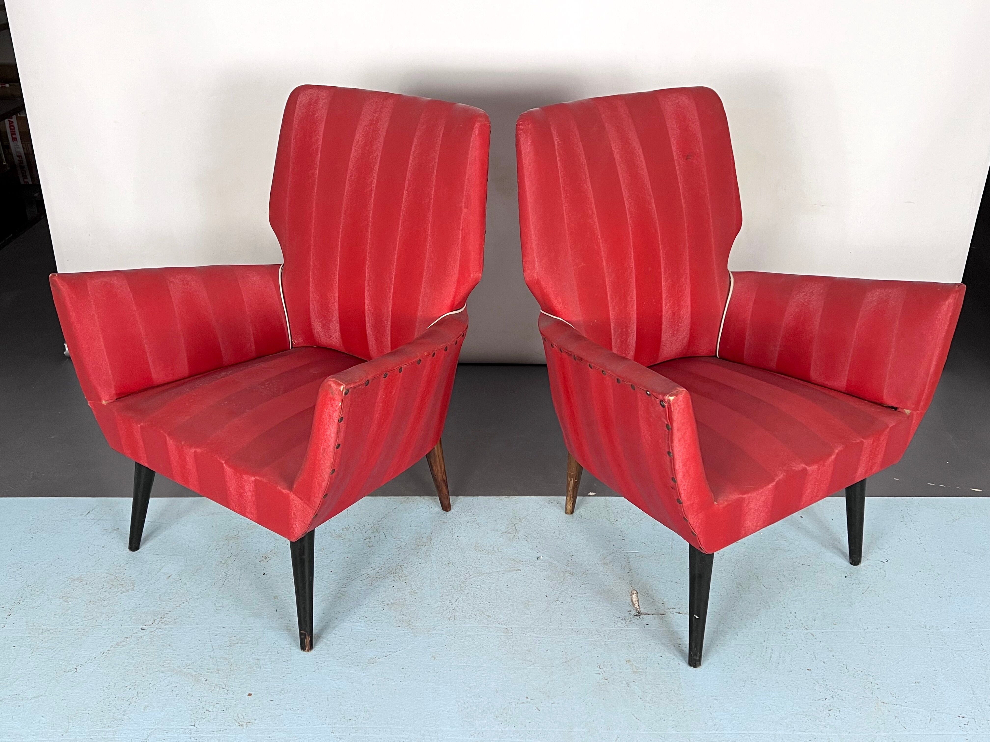 Mid-century modern pair of red armchairs. italy 1950s