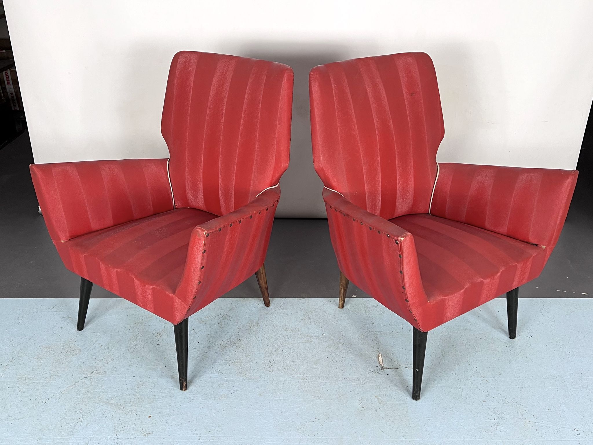 Mid-century modern pair of red armchairs. italy 1950s