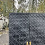 Contemporary wardrobe in black faux leather with diamond pattern and gold handles.