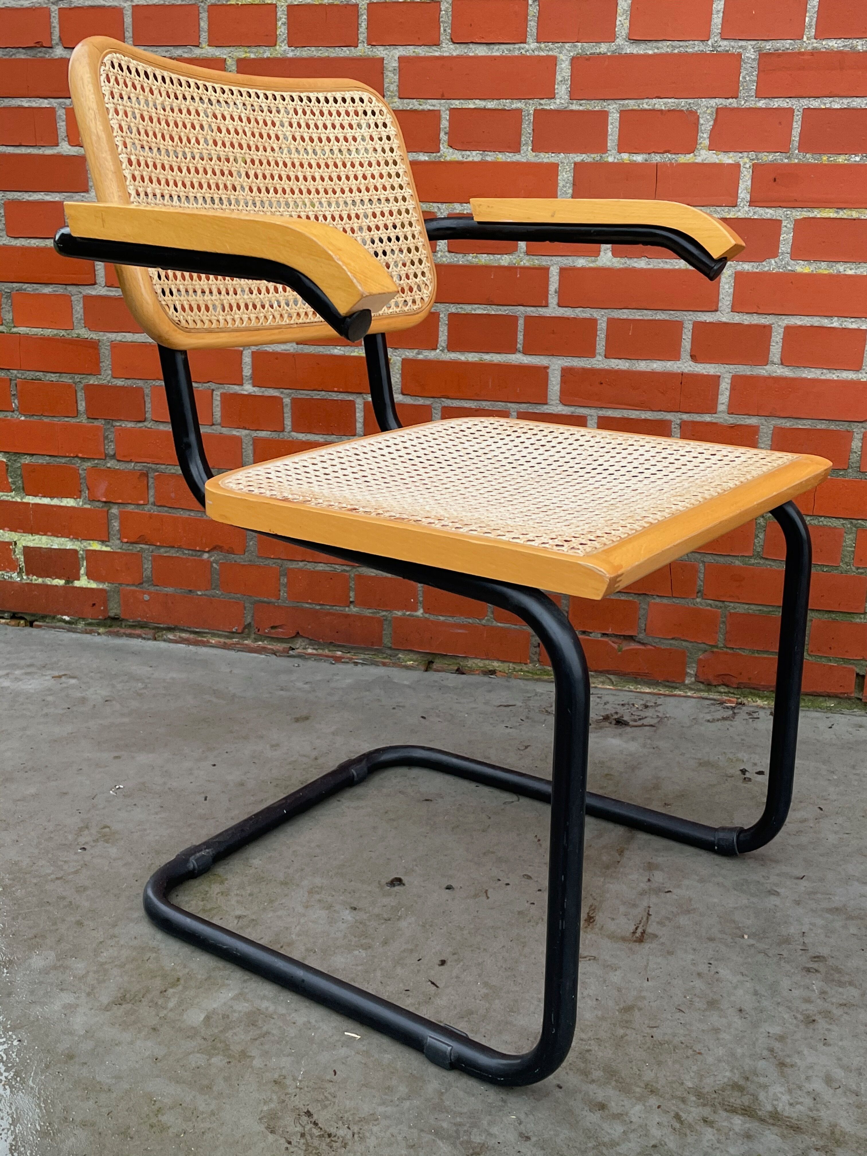 Cesca model chair designed by Marcel Breuer with black-framed armrests