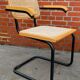 Cesca model chair designed by Marcel Breuer with black-framed armrests