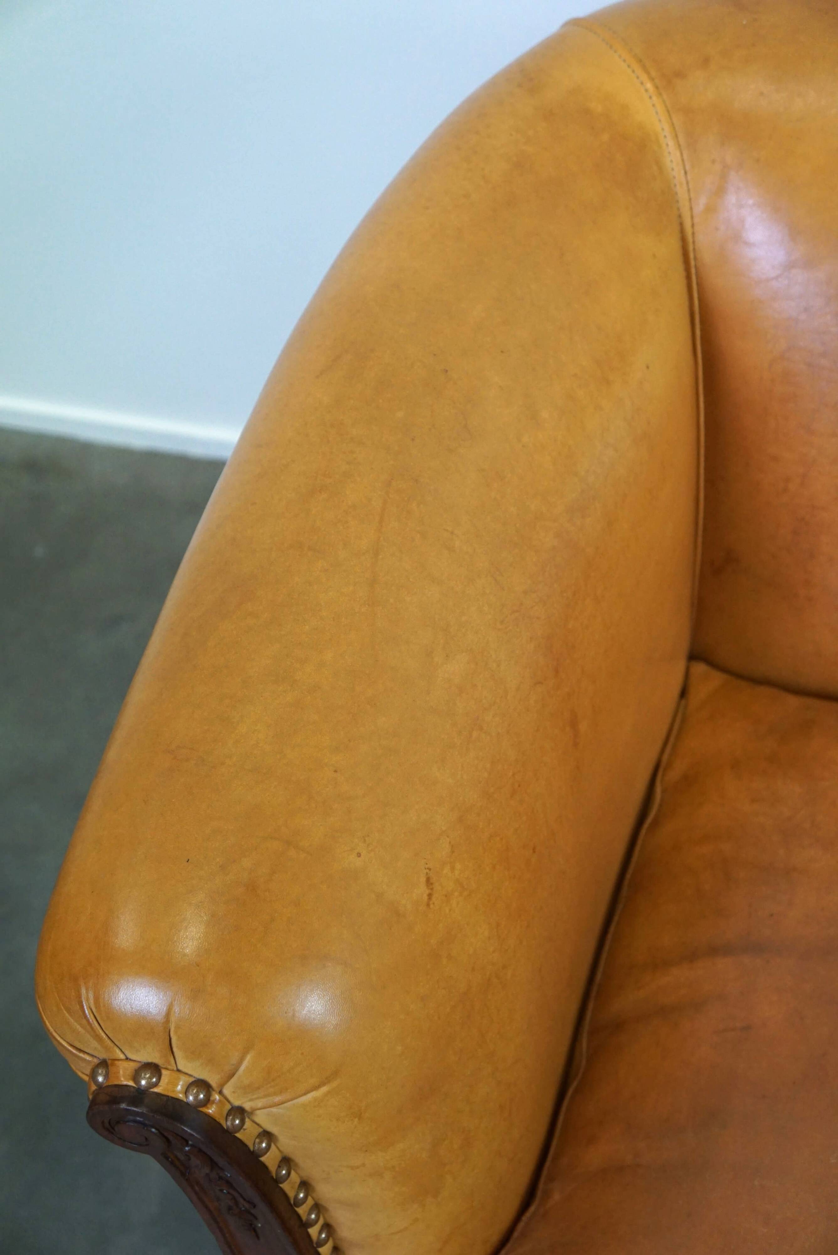 Unique old set of 2 club armchairs and a couch in cognac-colored leather with wheels