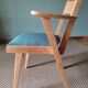 Scandinavian armchairs with green tapered legs.