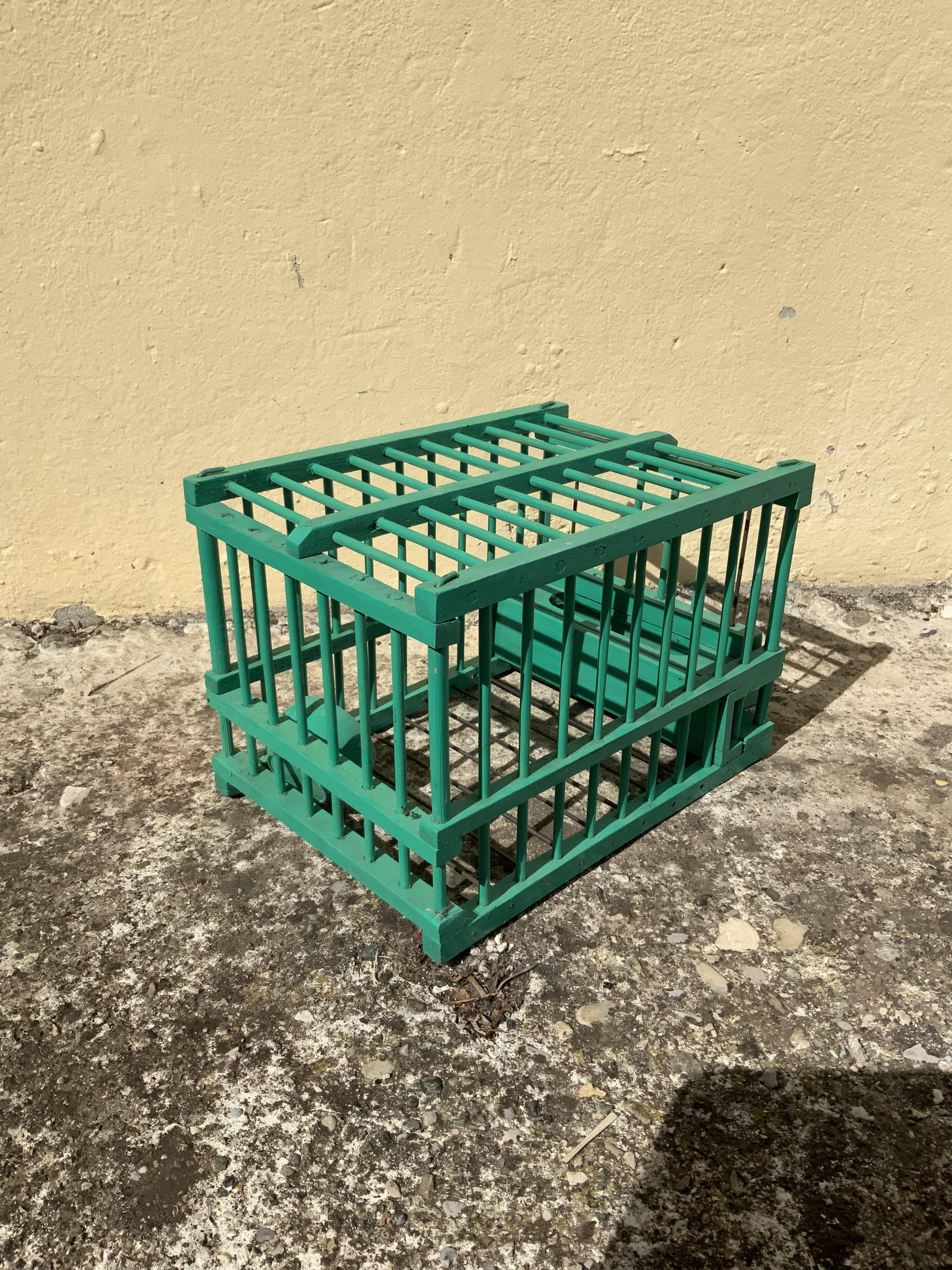 Vintage bird cage in green wood retro paint