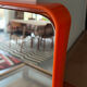Orange moulded plastic mirror