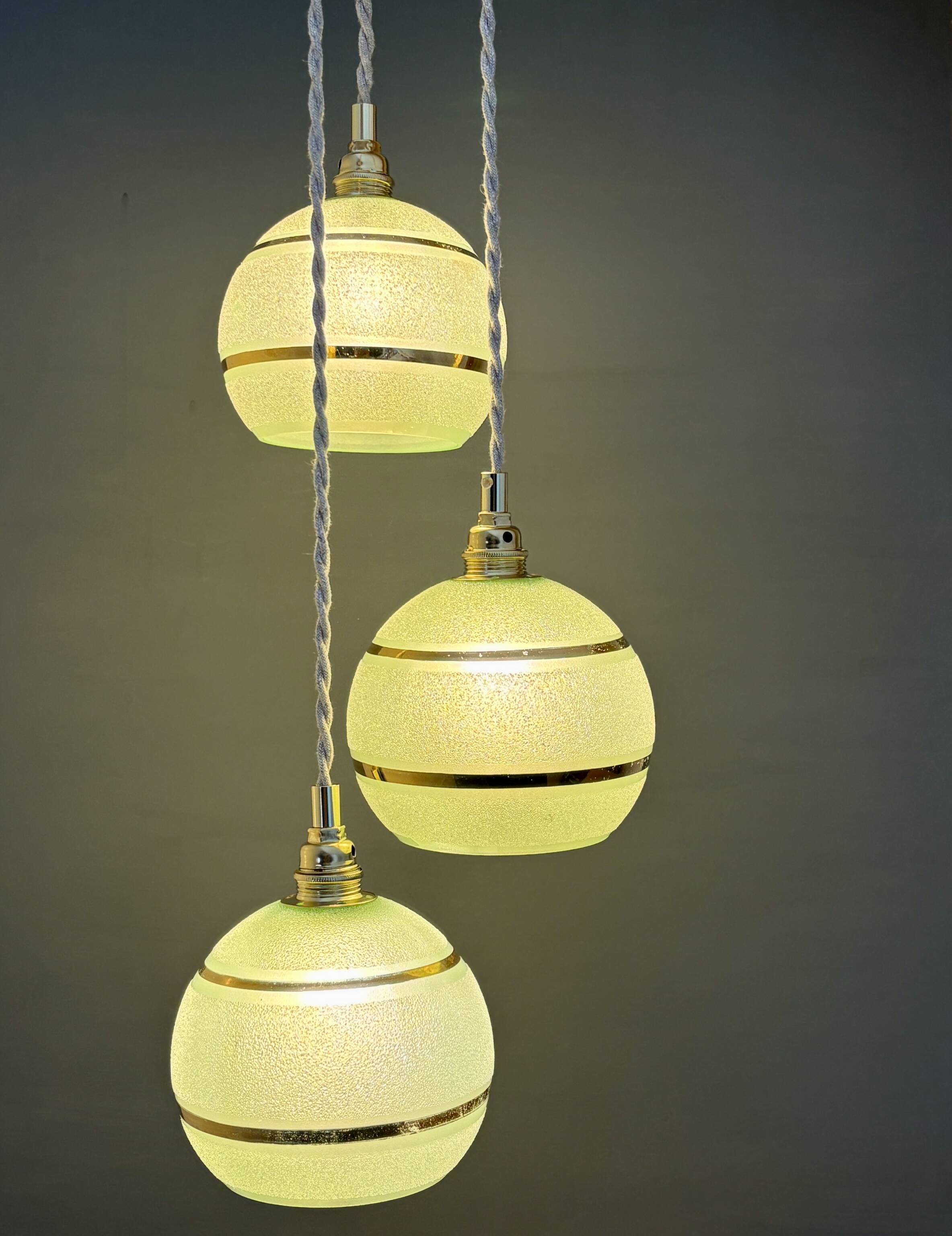 Suspension triple vintage glass globes in frosted green and gold.
