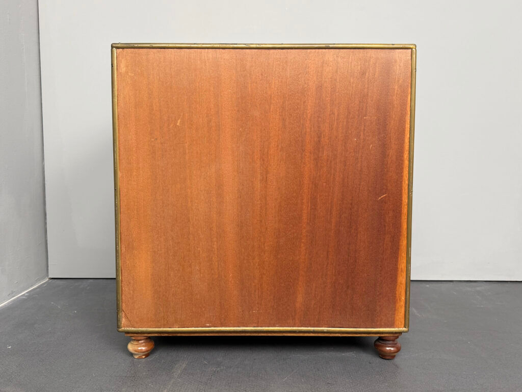 Antique campaign chest / ship’s chest, England, 1940s. Mahogany with a distinctive grain, brass inlays and hardware.