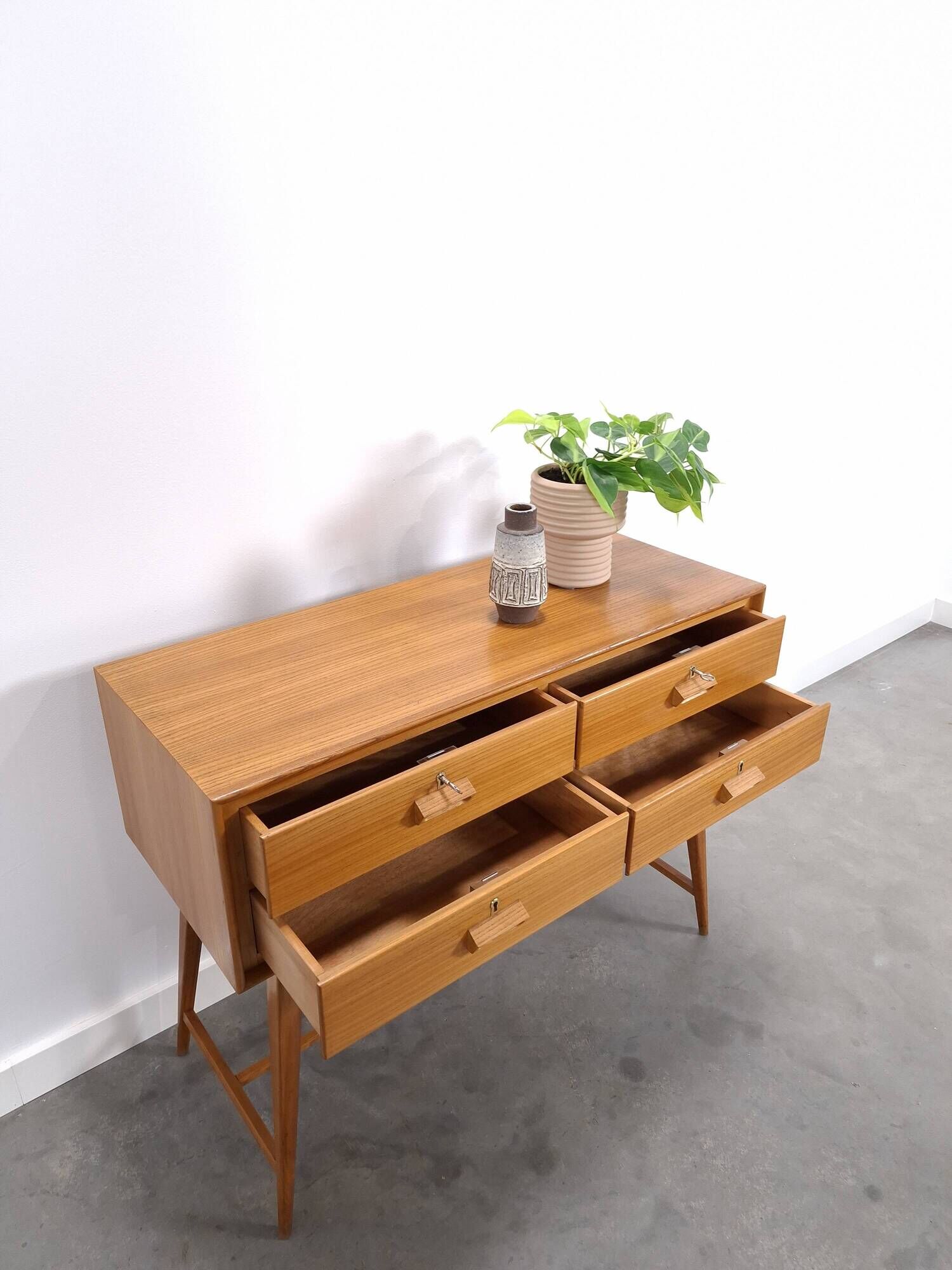 Vintage teak Danish chest of drawers with high slanted legs, side table, sideboard.