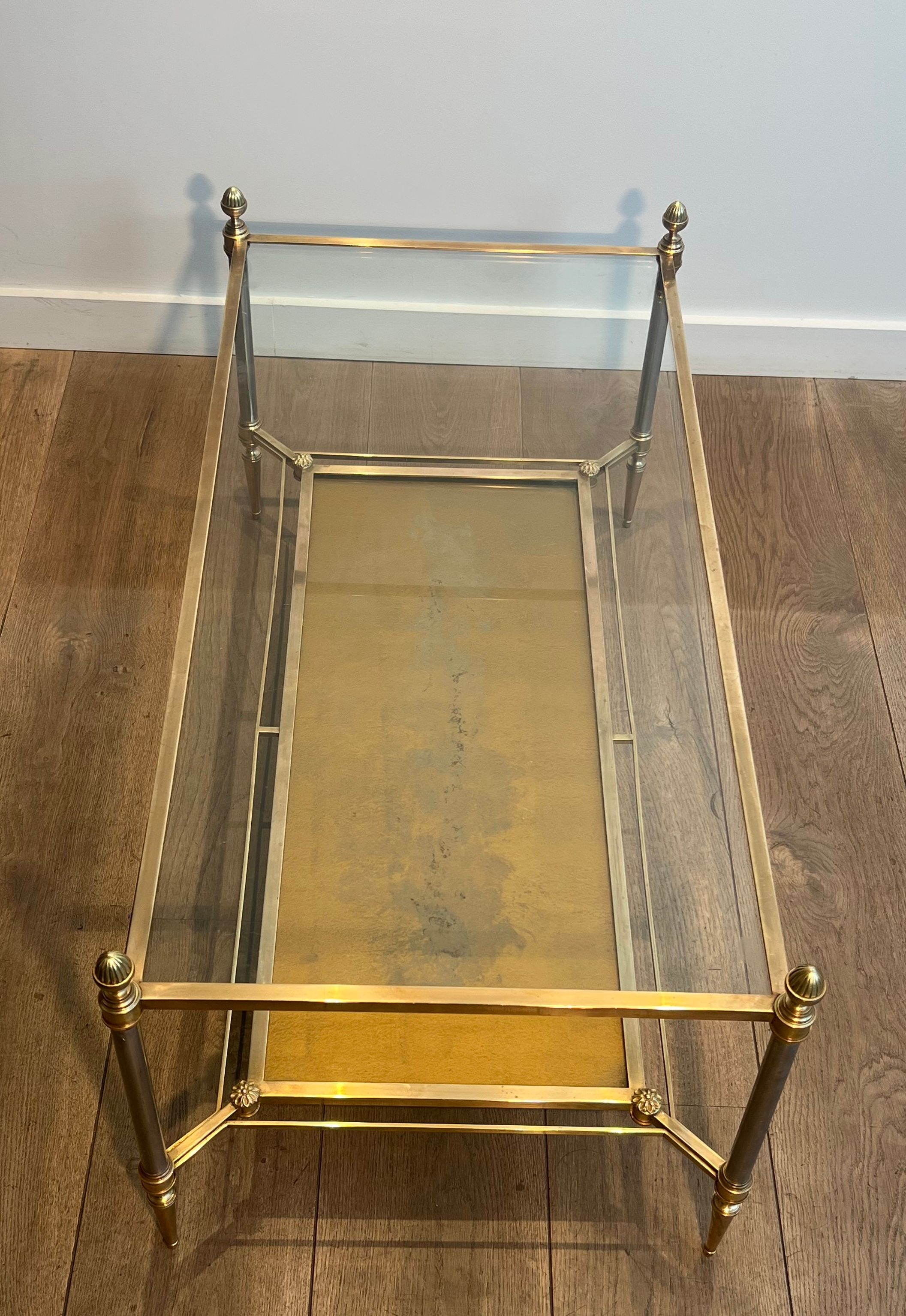 Coffee table in brass, brushed steel, glass, and gilded eglomisé mirror from Maison Jansen.