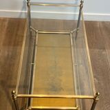 Coffee table in brass, brushed steel, glass, and gilded eglomisé mirror from Maison Jansen.