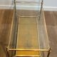 Coffee table in brass, brushed steel, glass, and gilded eglomisé mirror from Maison Jansen.