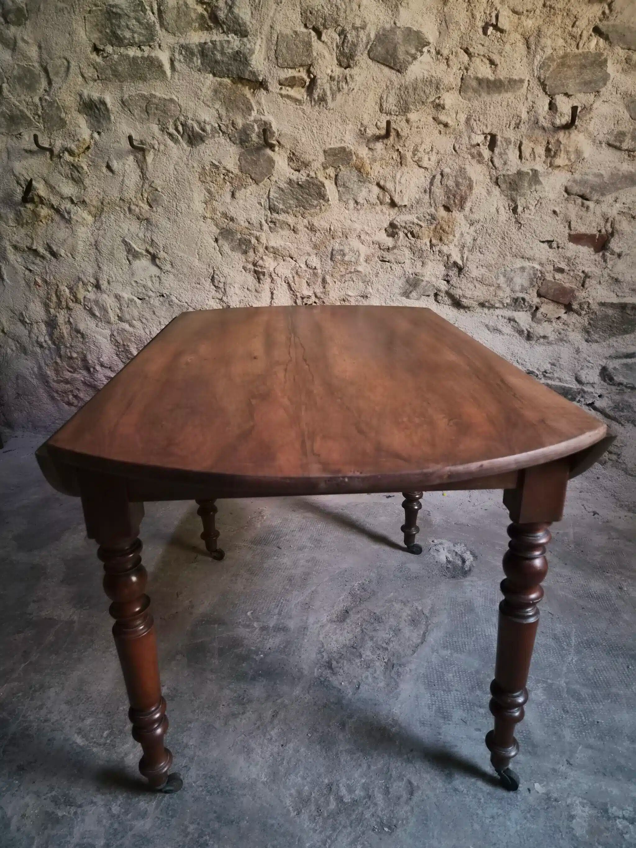 Antique drop-leaf dining table in walnut, France, circa 1900.