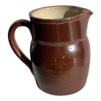 Pitcher in dark brown sandstone glazed with dotted frieze patterns