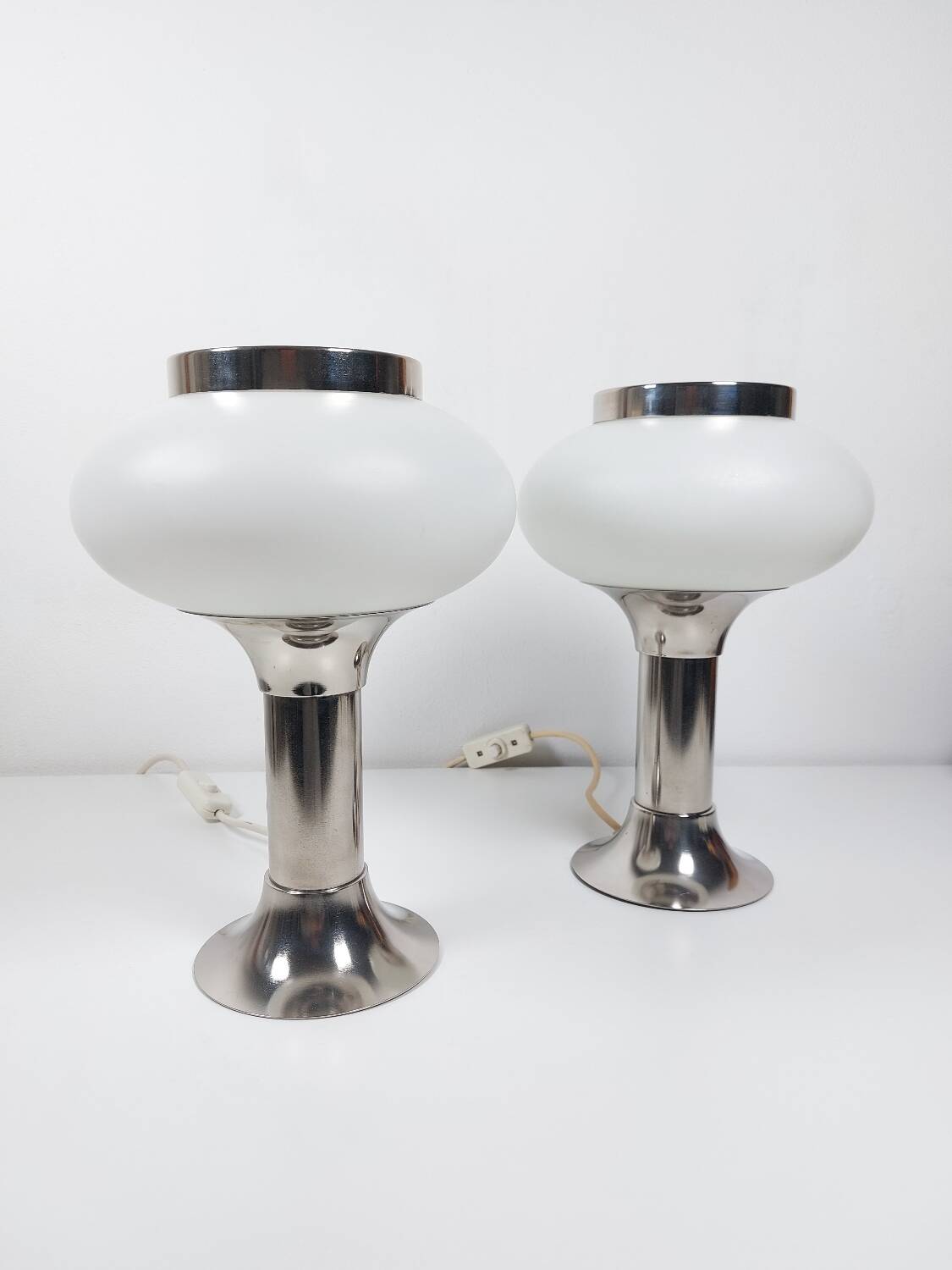 Pair of vintage futuristic style table lamps in chrome and opal glass.