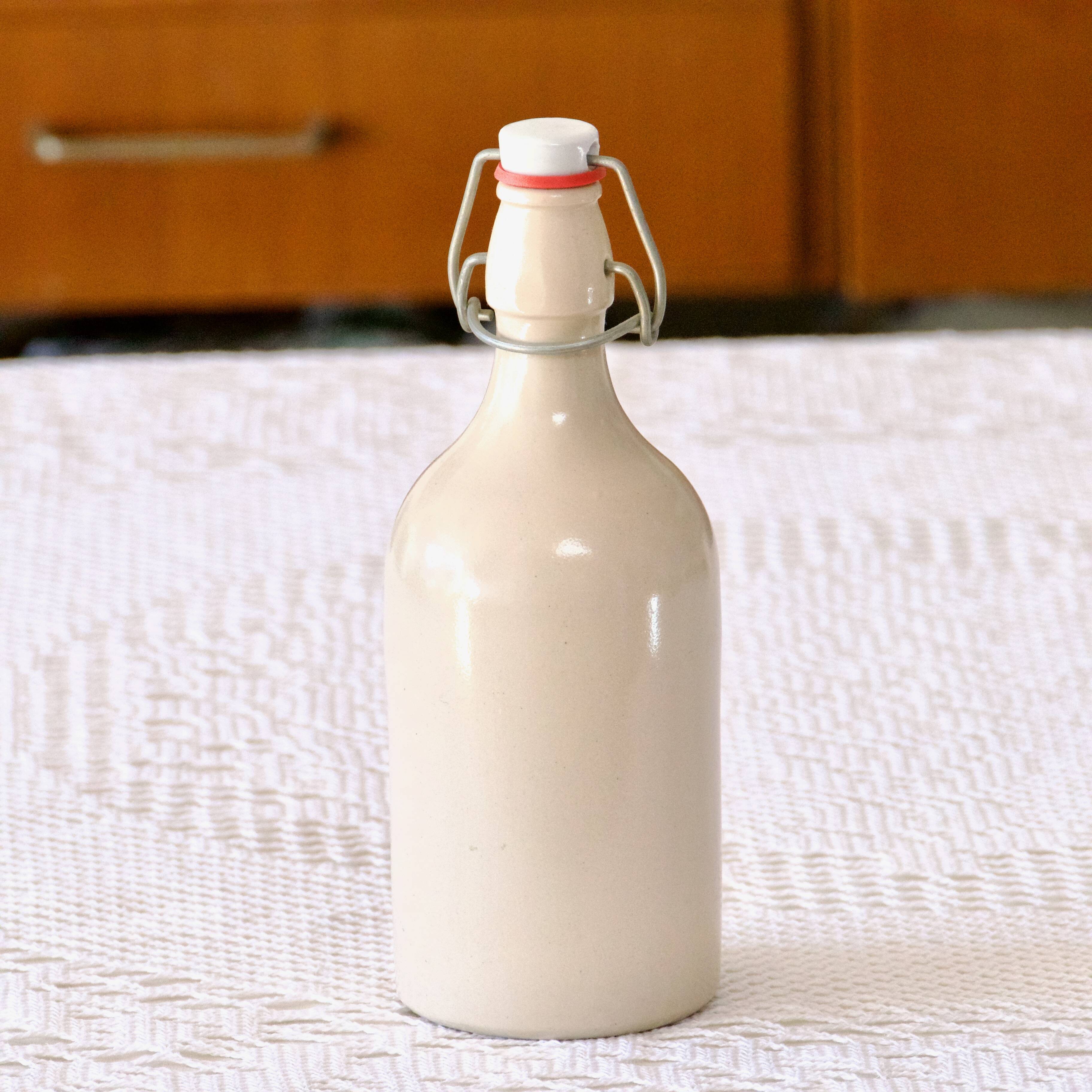 Antique enamelled stoneware beer bottle signed MKM