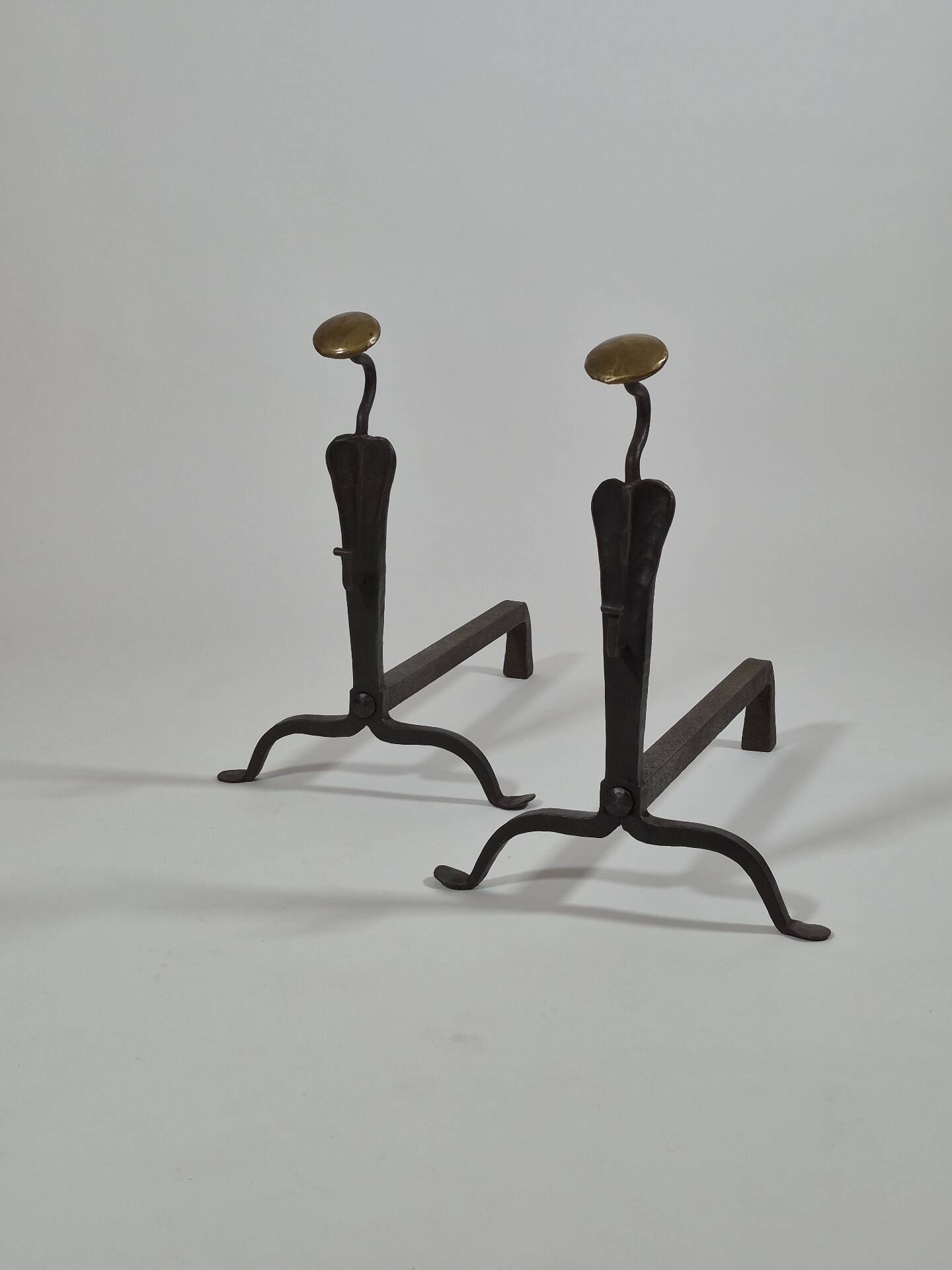 Pair of handforged metal and brass andirons