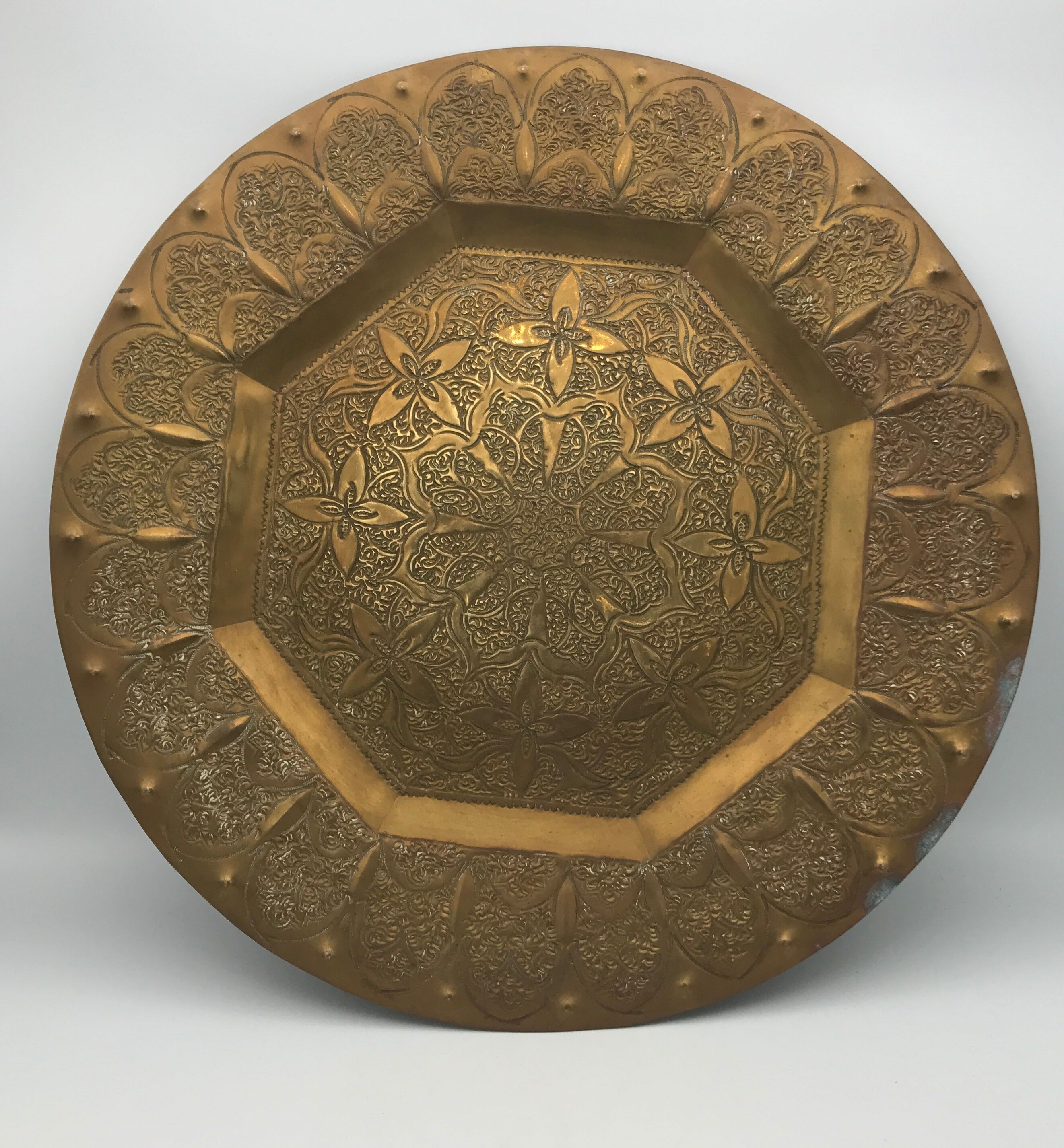 Oriental brass tray with chiseled decoration of arabesques and flowers