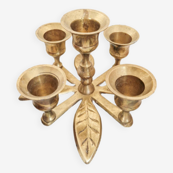 Golden brass candle holder in the shape of vintage flowers
