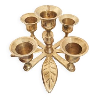 Golden brass candle holder in the shape of vintage flowers