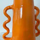 Handmade abstract orange ceramic vase with wavy handles