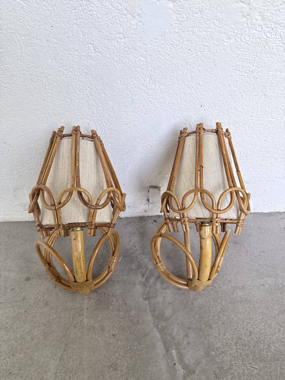 Pair of rattan wall lights by Louis Sognot, 1960.