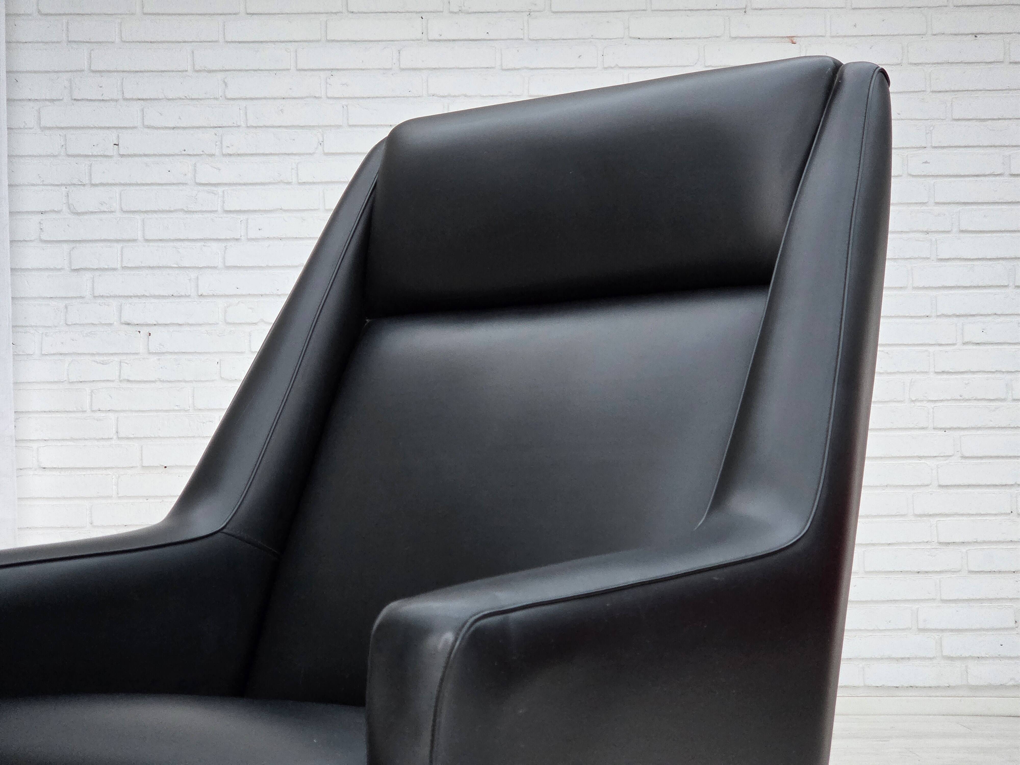 1970s, Danish highback armchair, black artificial leather, teak wood legs.