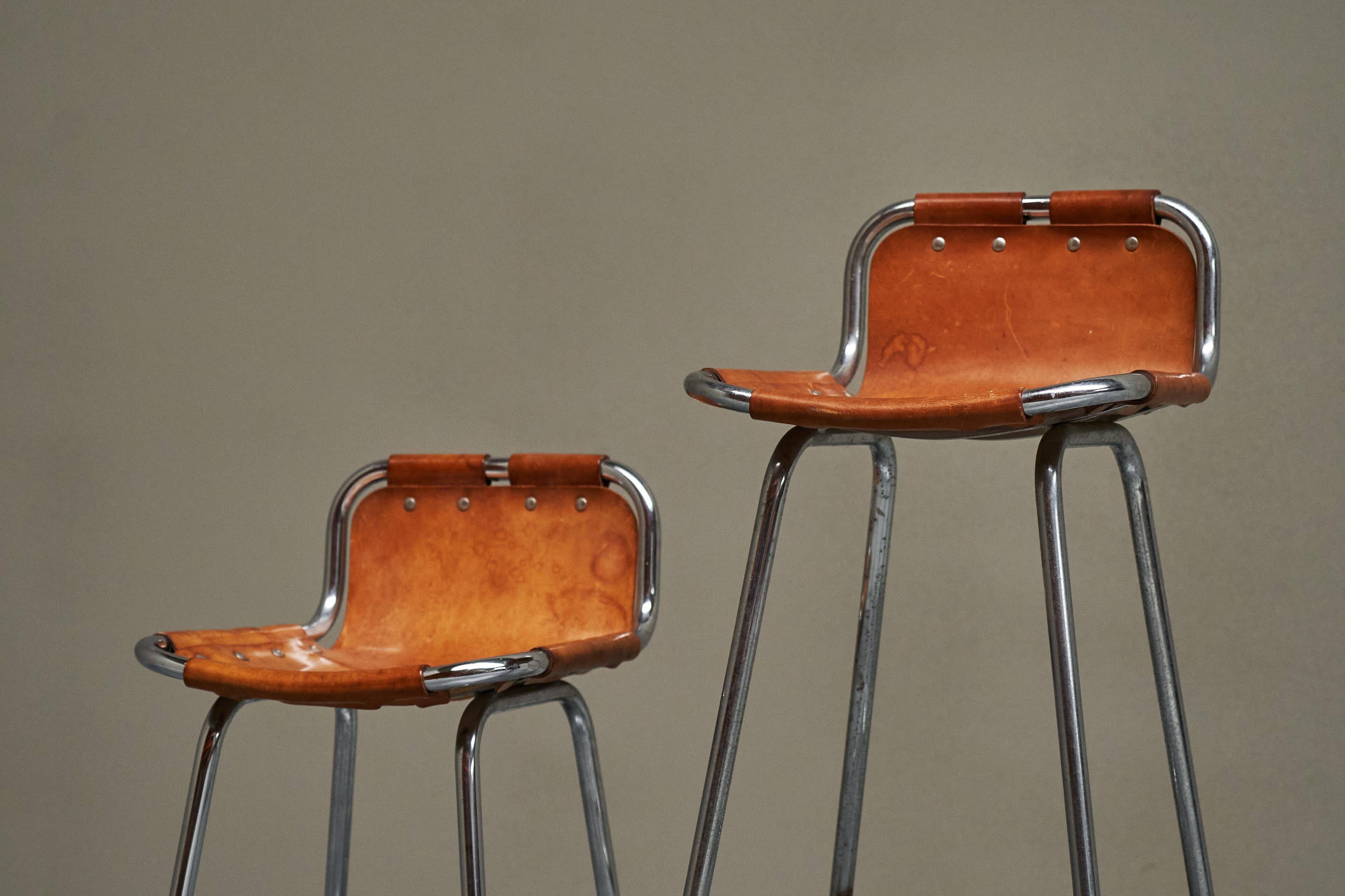 Set of 2 stools "Les Arcs" selected by Charlotte Perriand in leather.