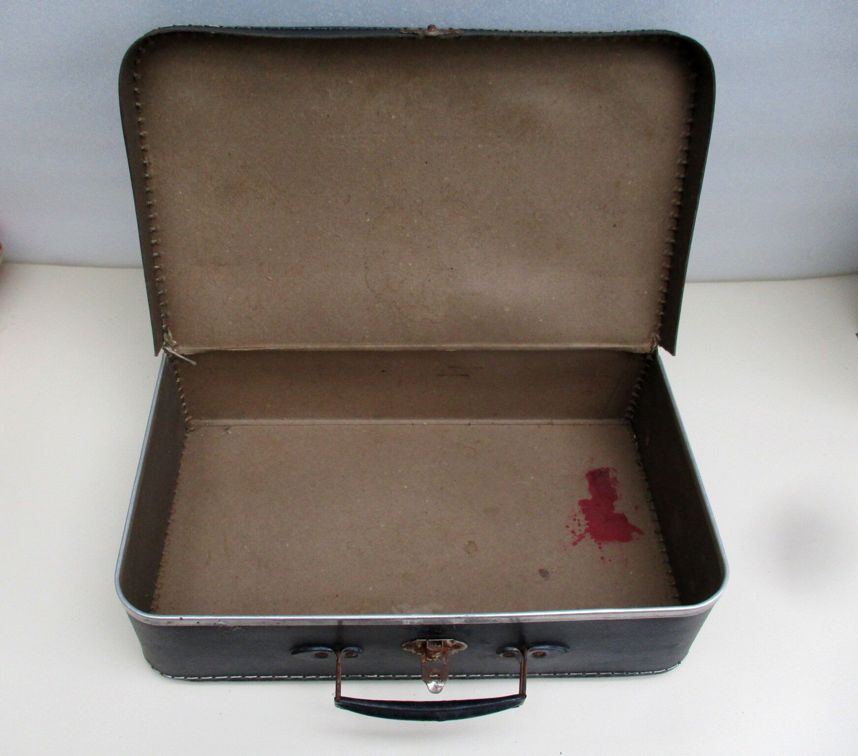 Small suitcase in old navy blue cardboard