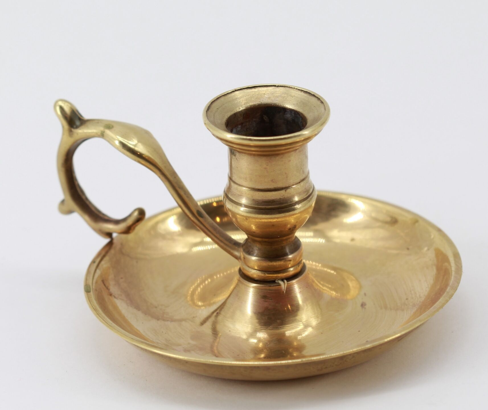 Old brass hand candle holder