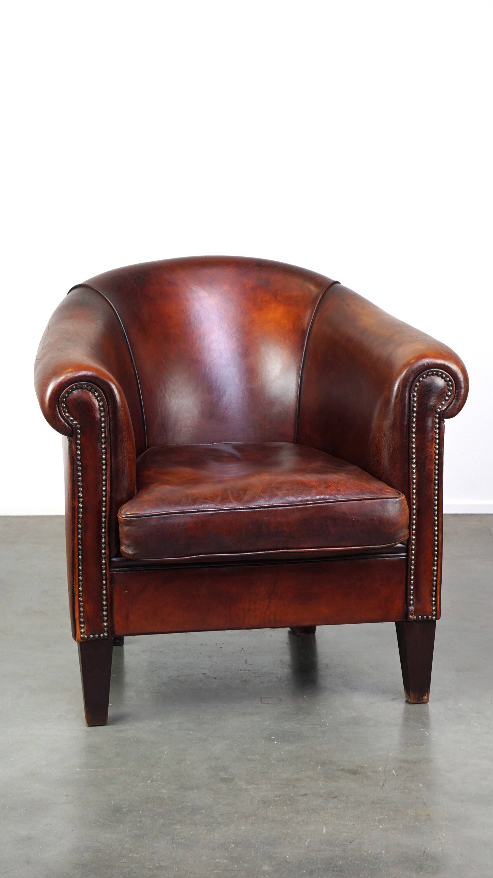 Very luxurious dark brown sheepskin club chair with a more than beautiful patina