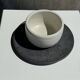 White Indonesian ceramic cup and gray saucer
