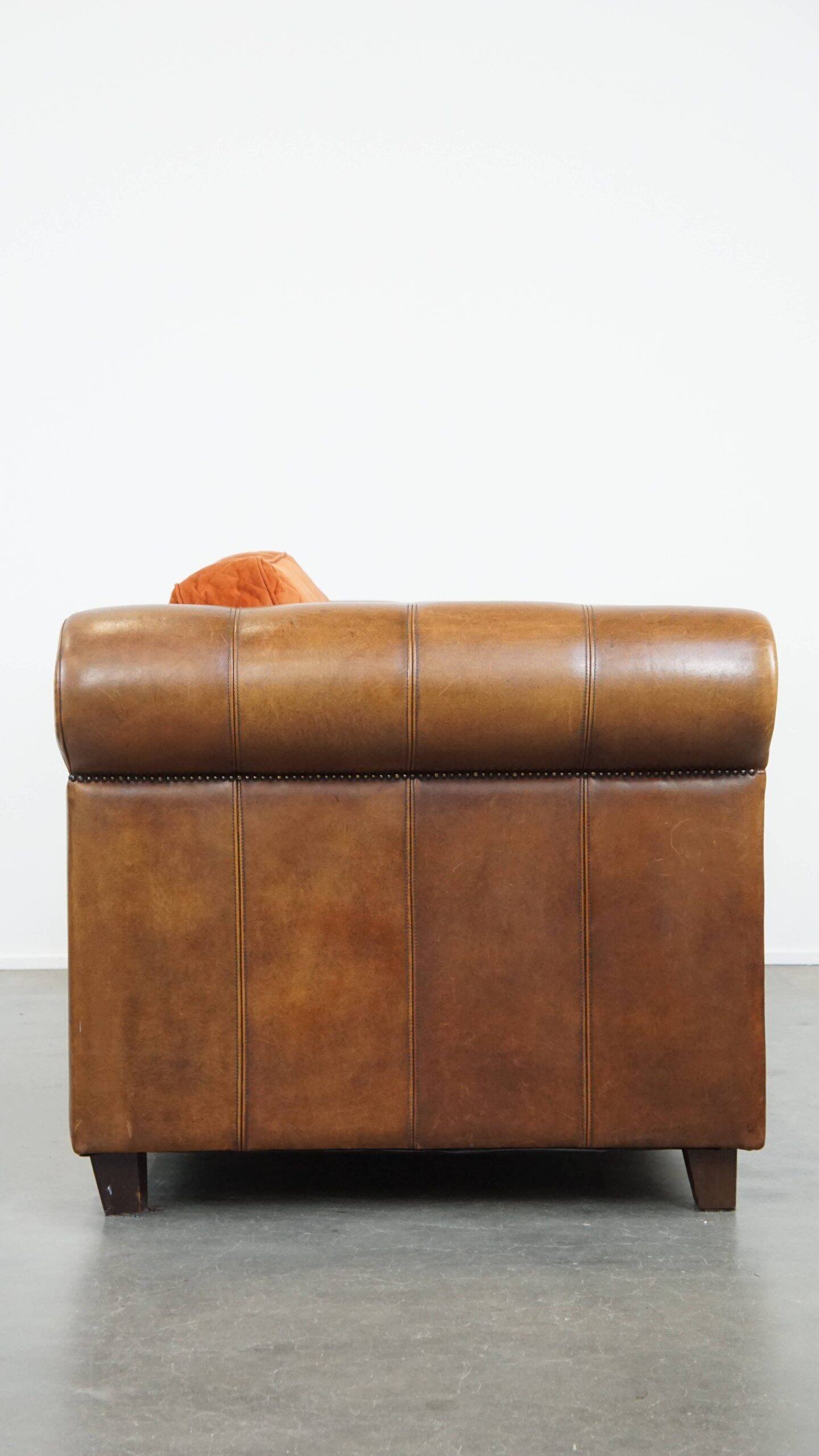 Luxury and comfortable sheepskin 2.5-seater sofa of top quality with orange fabric seat and back cushions