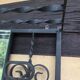Large vintage wall coat rack in wrought iron with mirror and shelf.