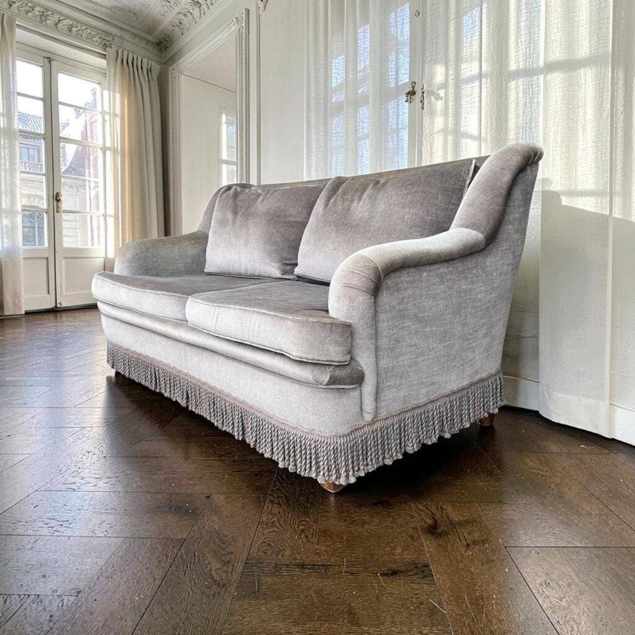 Vintage taupe two-seater armchair/sofa with fringes.