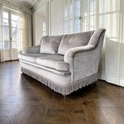 Vintage taupe two-seater armchair/sofa with fringes.