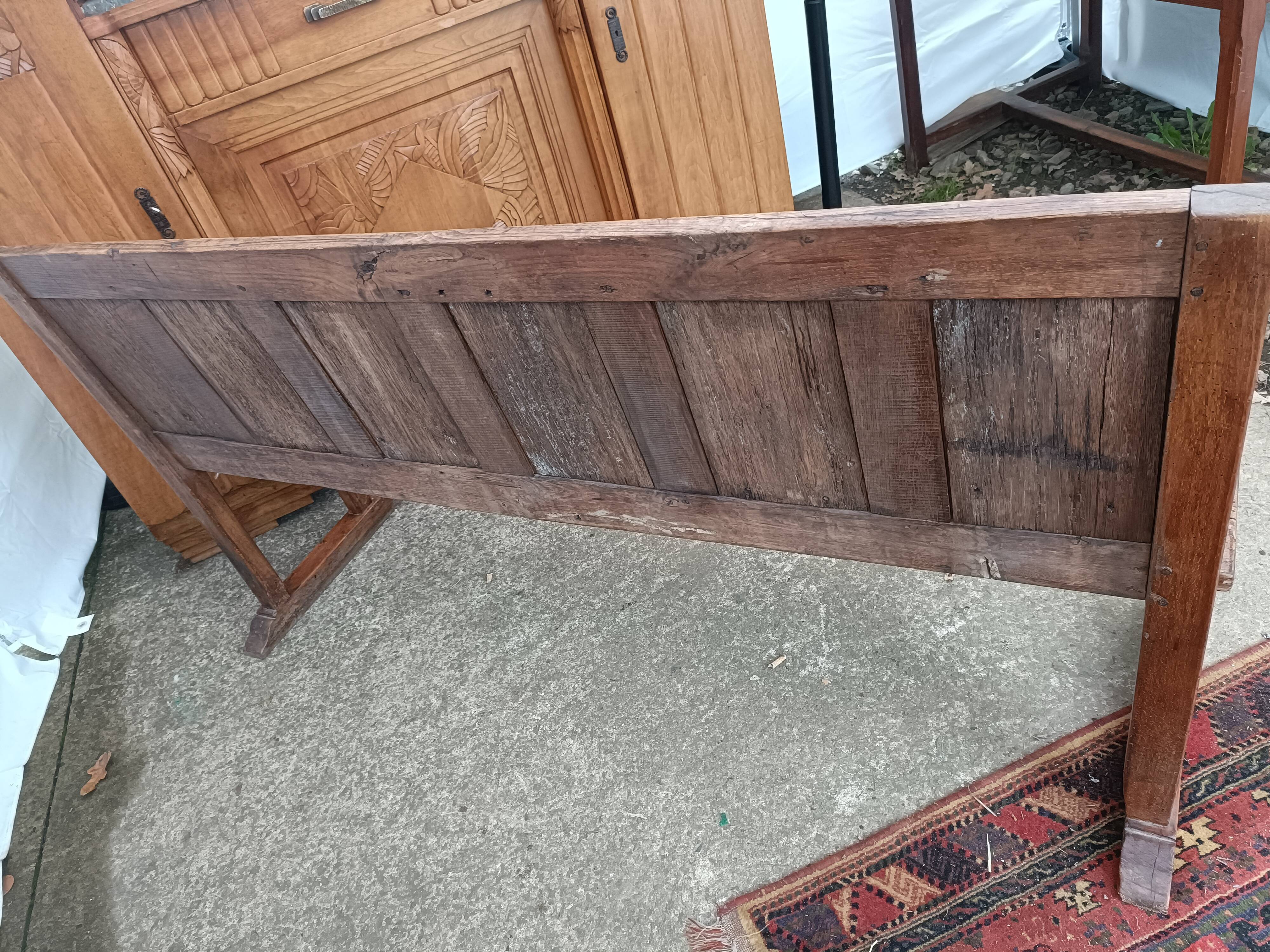 Oak church bench period XVII th century, back decorated with carved parchments