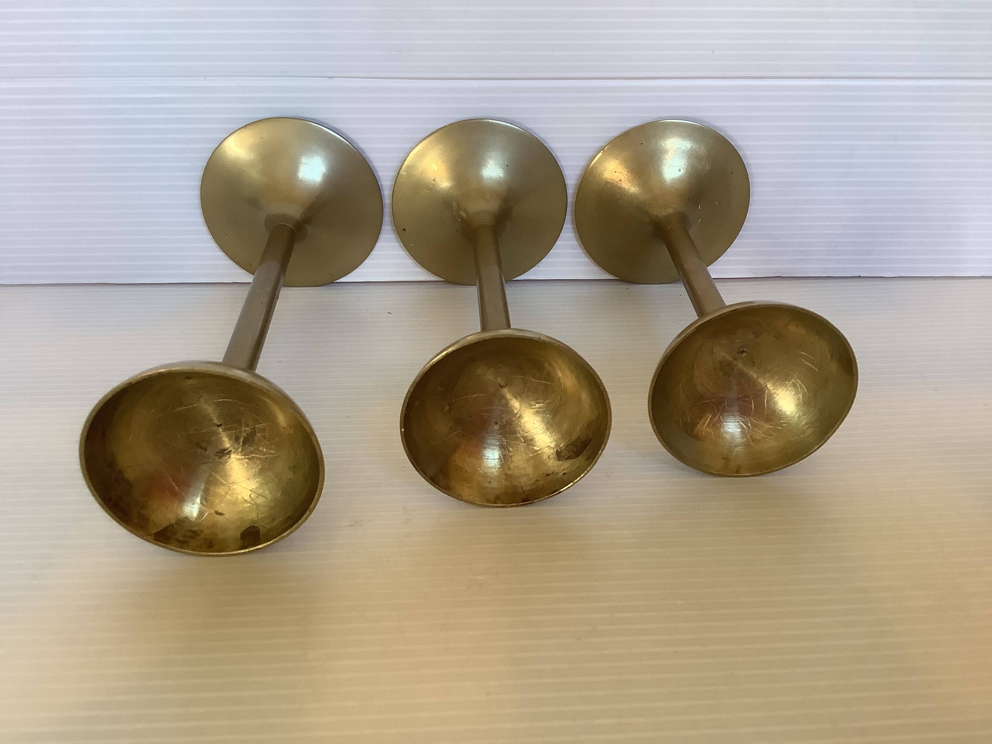 Trio of brass tulip foot candle holders