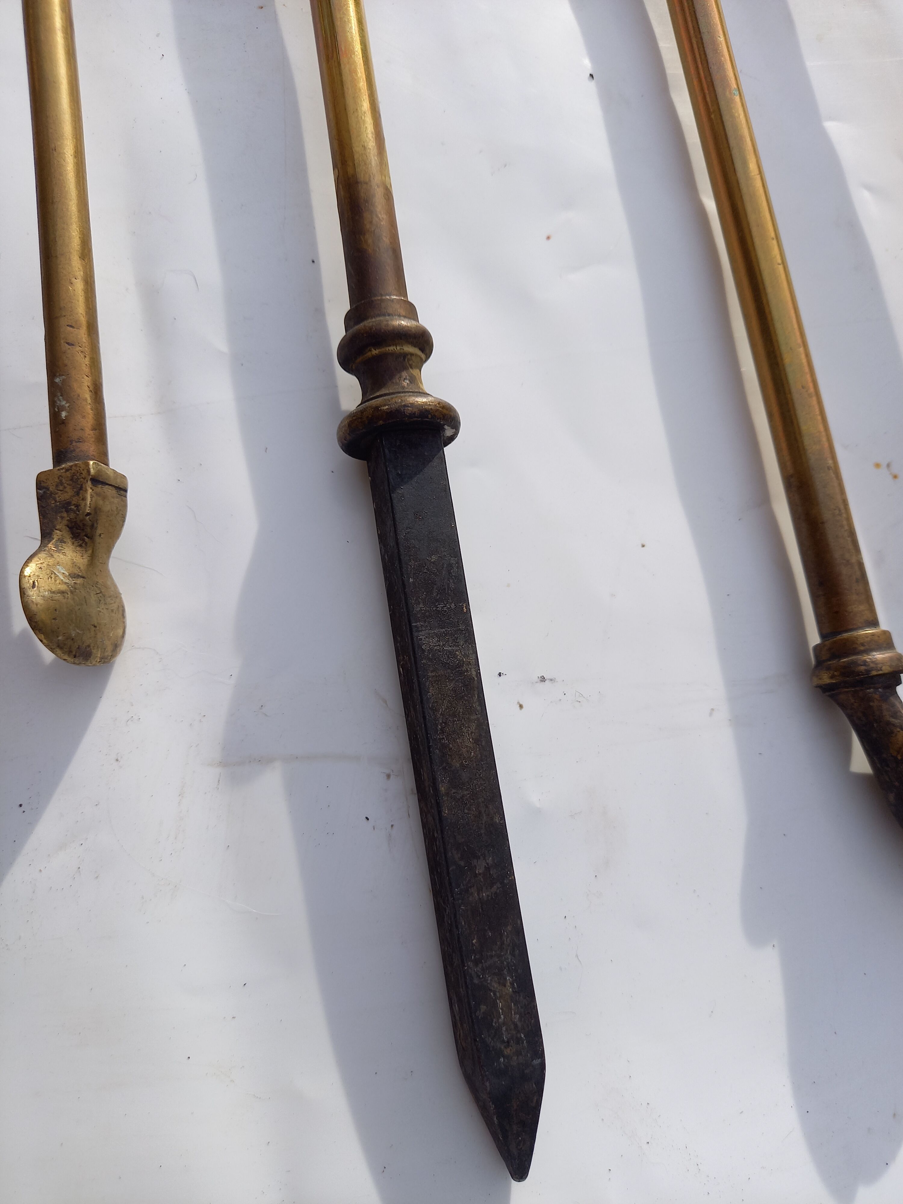 Mismatched set of chimney accessories two pliers and a fire pier
