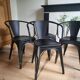 Black Tolix chair with armrests