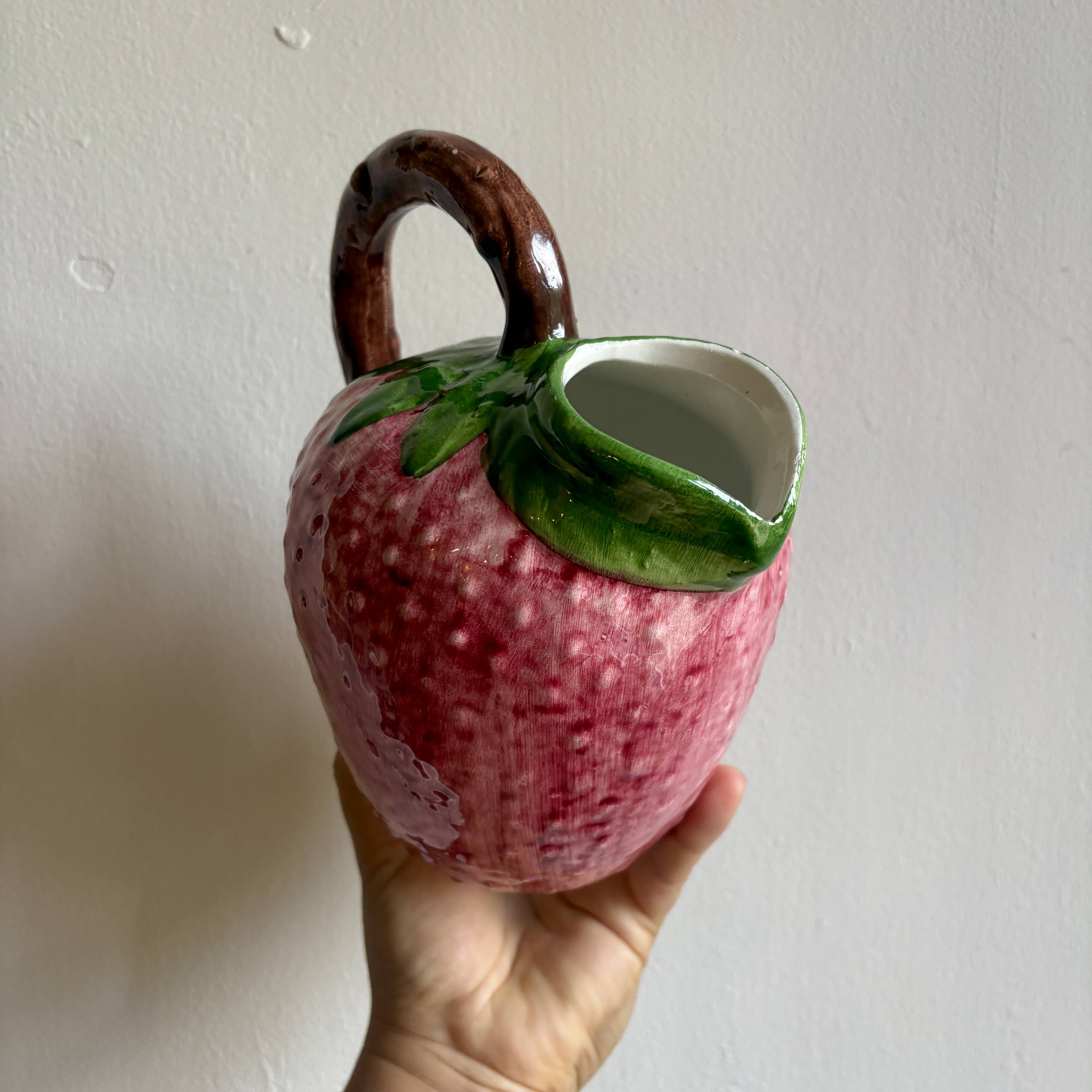 Ceramic jug in the shape of a strawberry.
