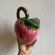 Ceramic jug in the shape of a strawberry.