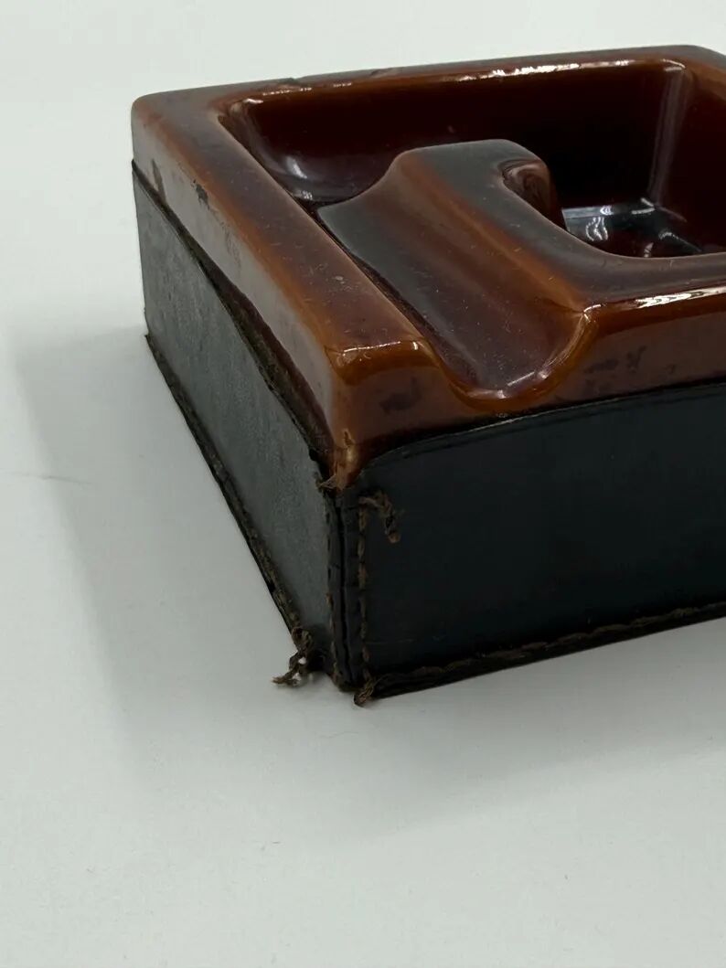 Geometric brown enamelled ashtray with a leather base (1960s-70s)